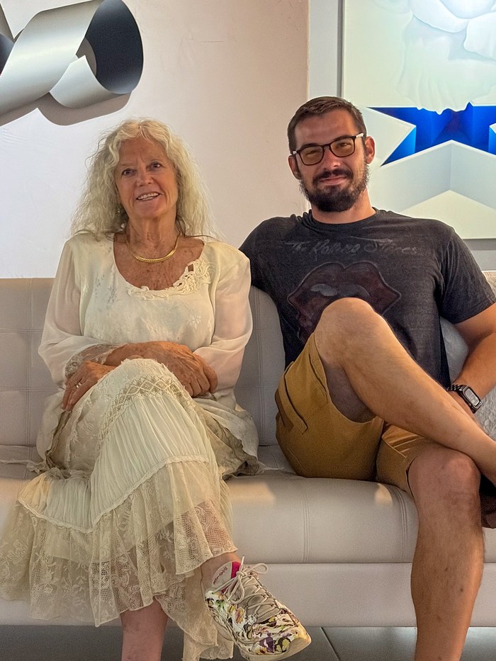 Lorraine Benini and filmmaker Jonny Goodday seated together during the museum visit