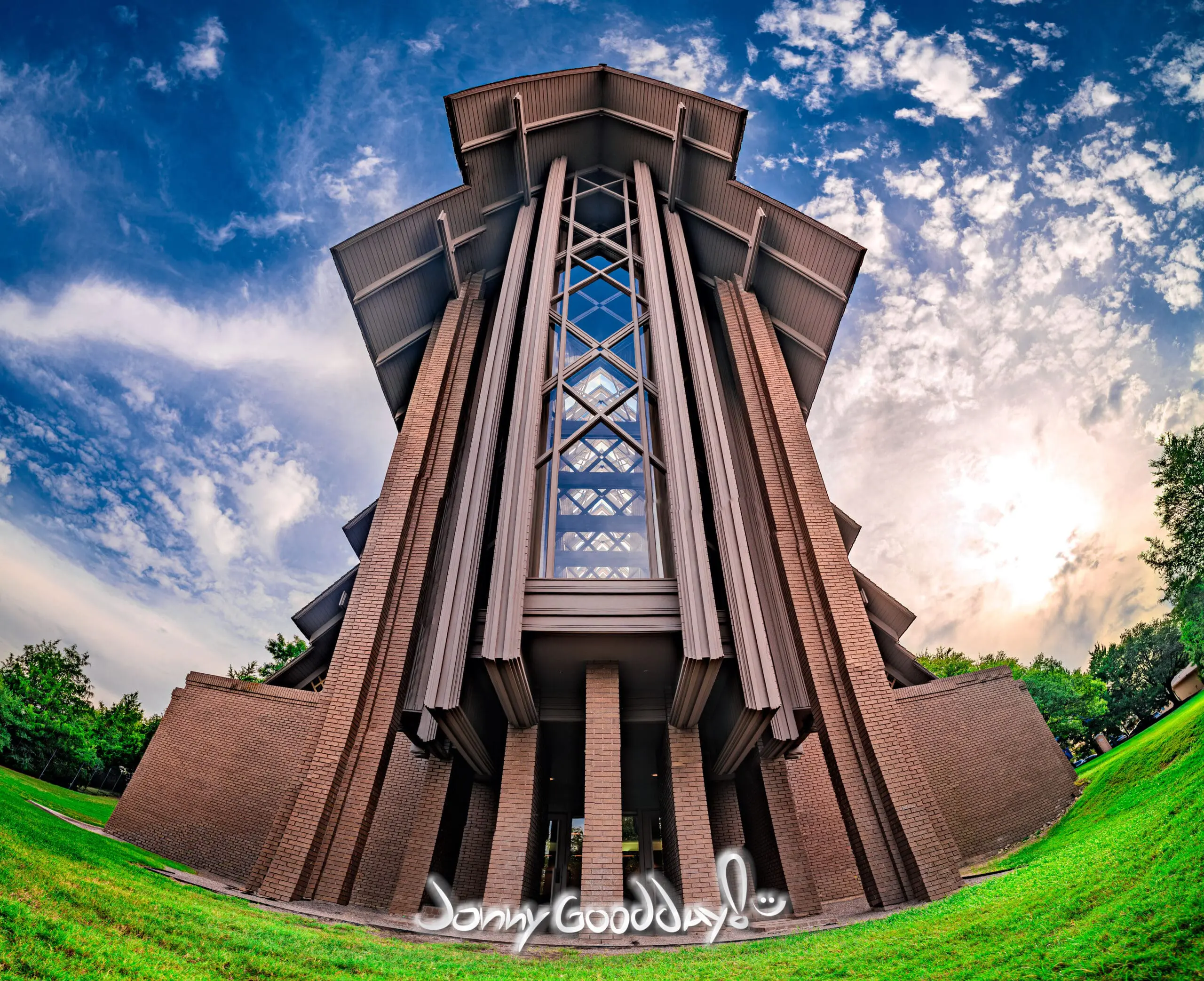 Low-angle exterior view of the Marty Leonard Community Chapel in Fort Worth against a dramatic blue sky