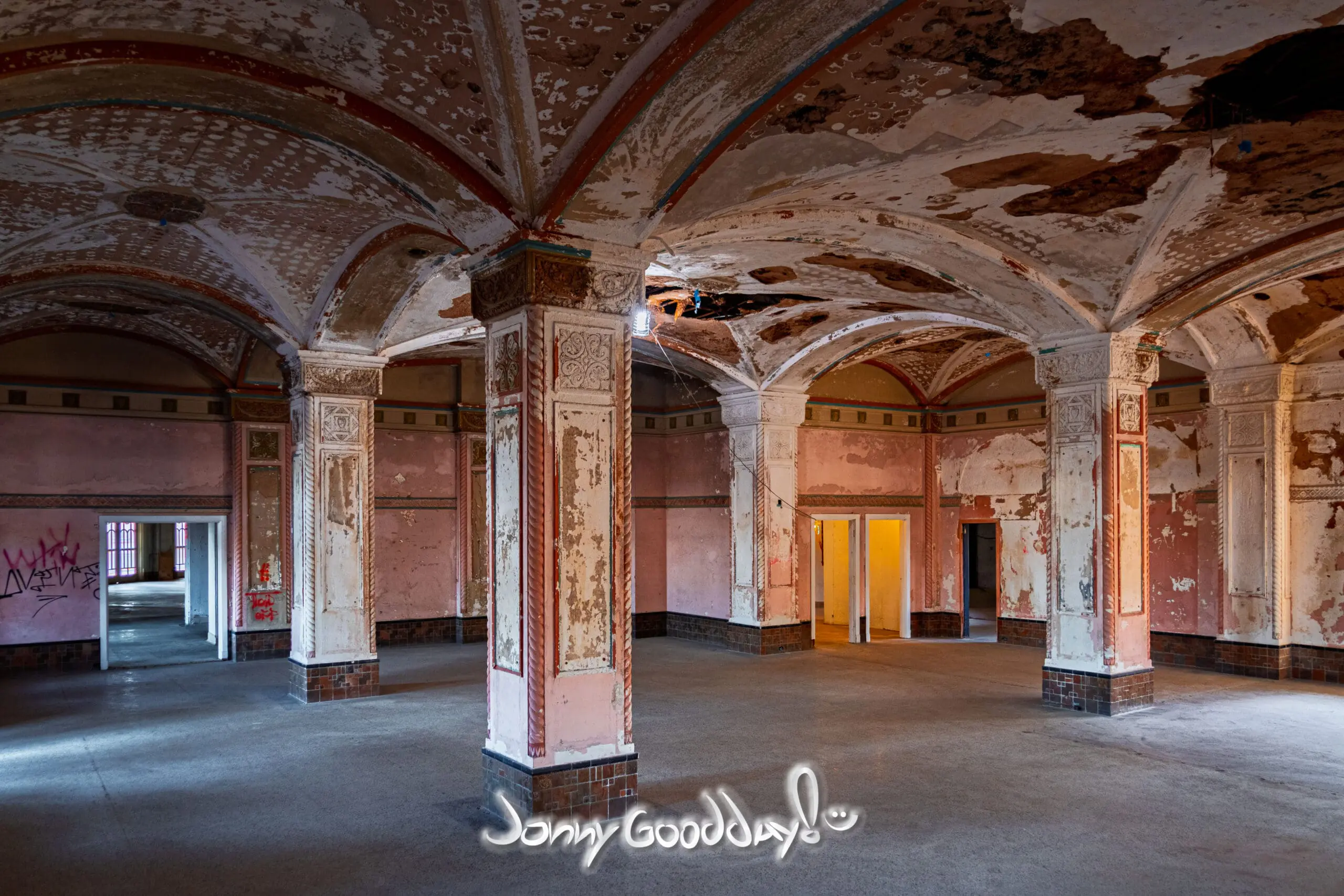 Historic Baker Hotel ballroom with ornate vaulted ceilings, columns, and peeling plaster