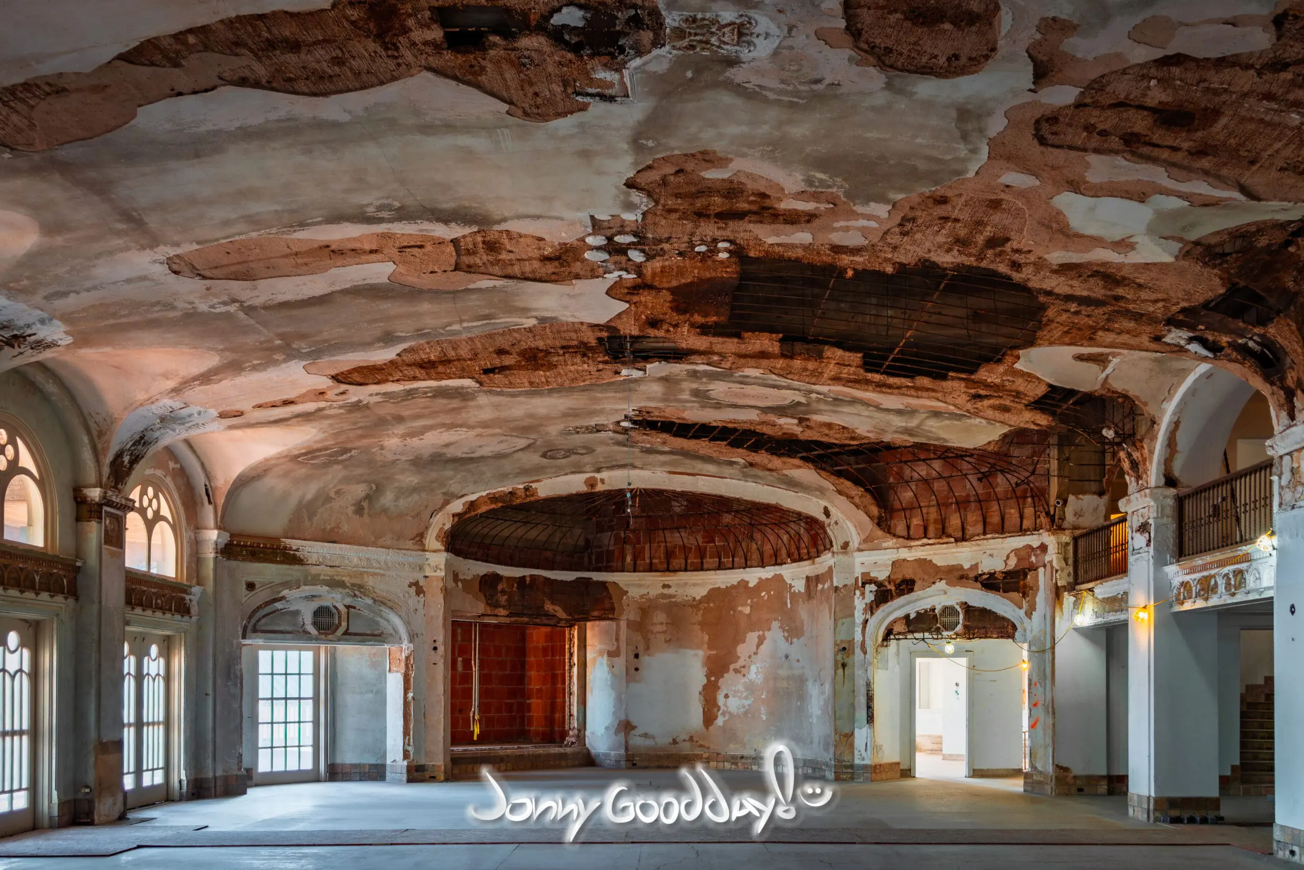 Deteriorated grand interior of the Baker Hotel with arched windows and exposed ceiling lath