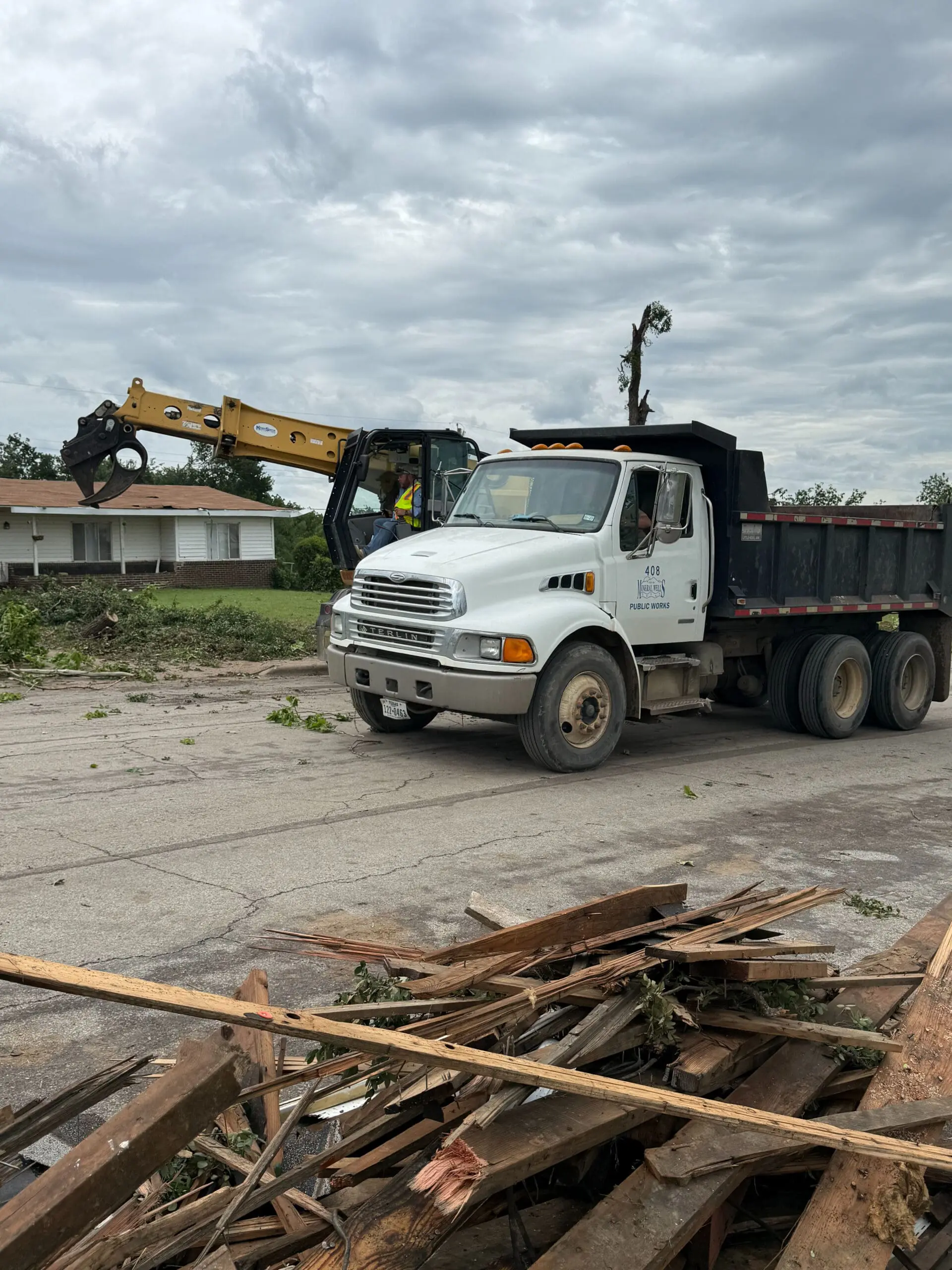 Mineral Wells public works crews remove tornado debris from a neighborhood