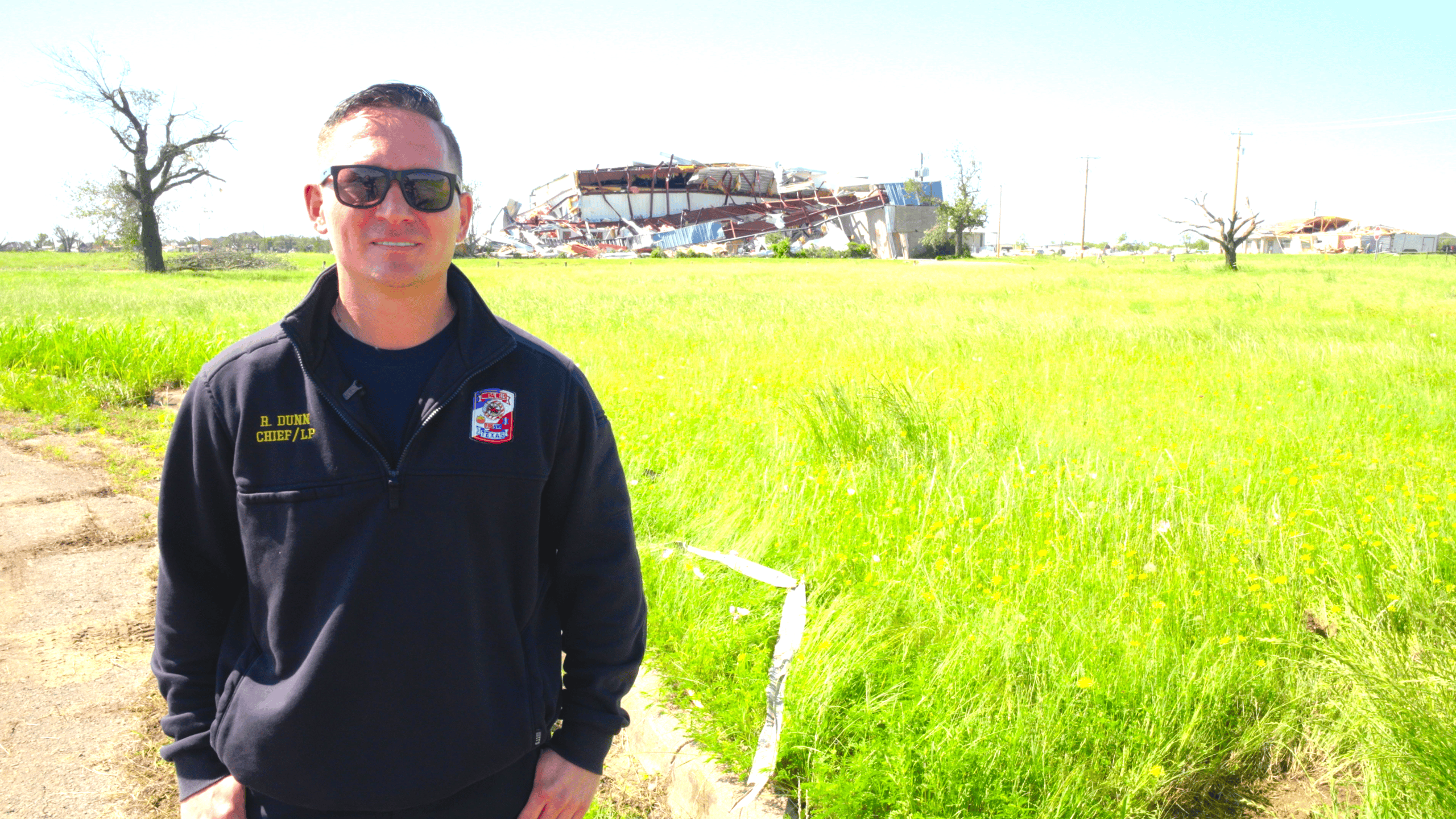 Mineral Wells Fire Chief Ryan Dunn near a building damaged by the April 2026 tornado