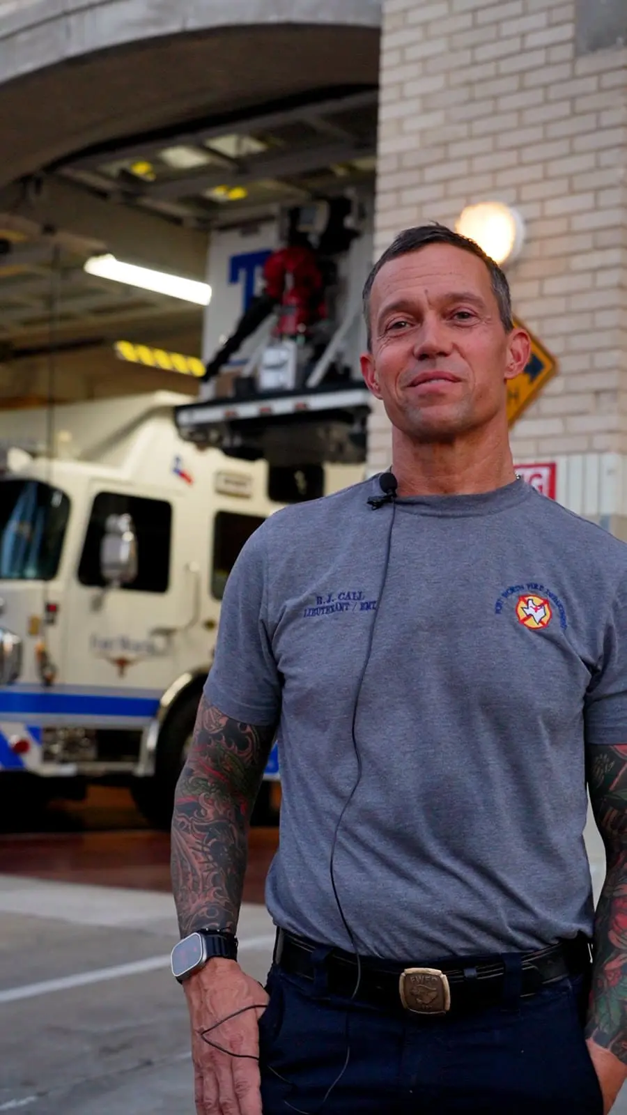 Lieutenant Brian Call inside Fort Worth Fire Station No. 2 with an engine behind him