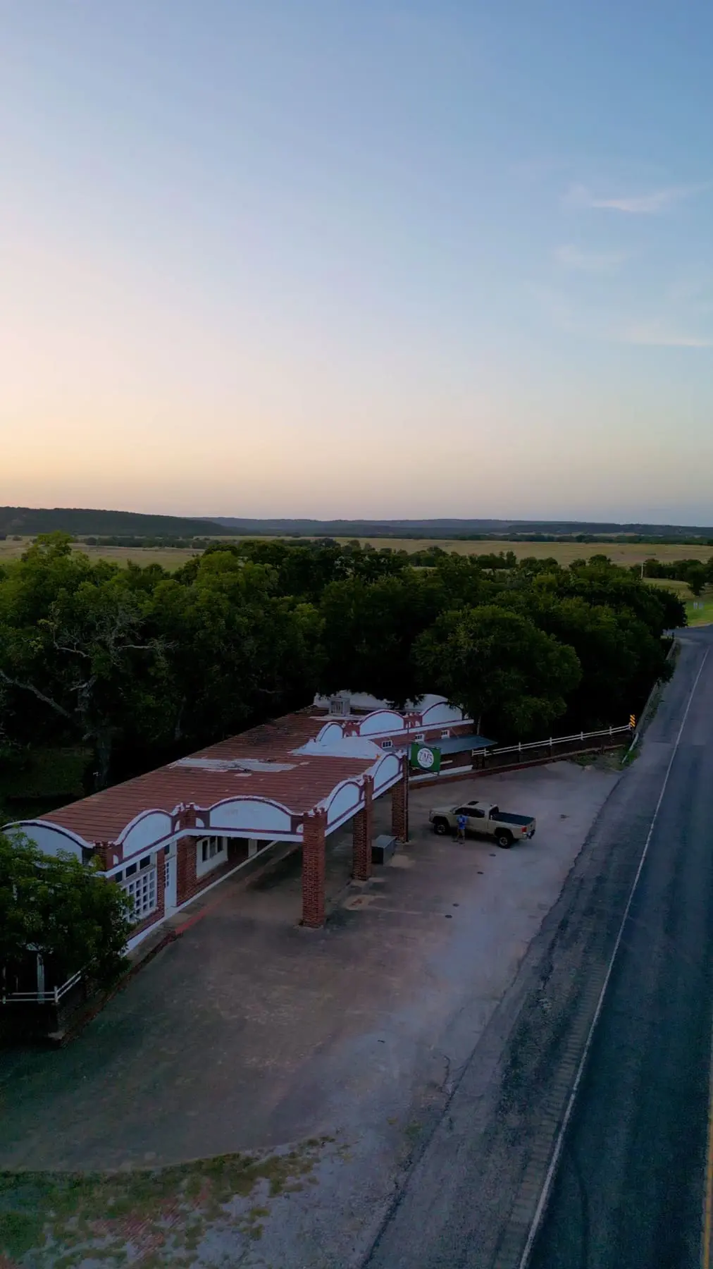 An aerial view of the historic Zim’s roadside building beside the highway in Strawn, Texas.