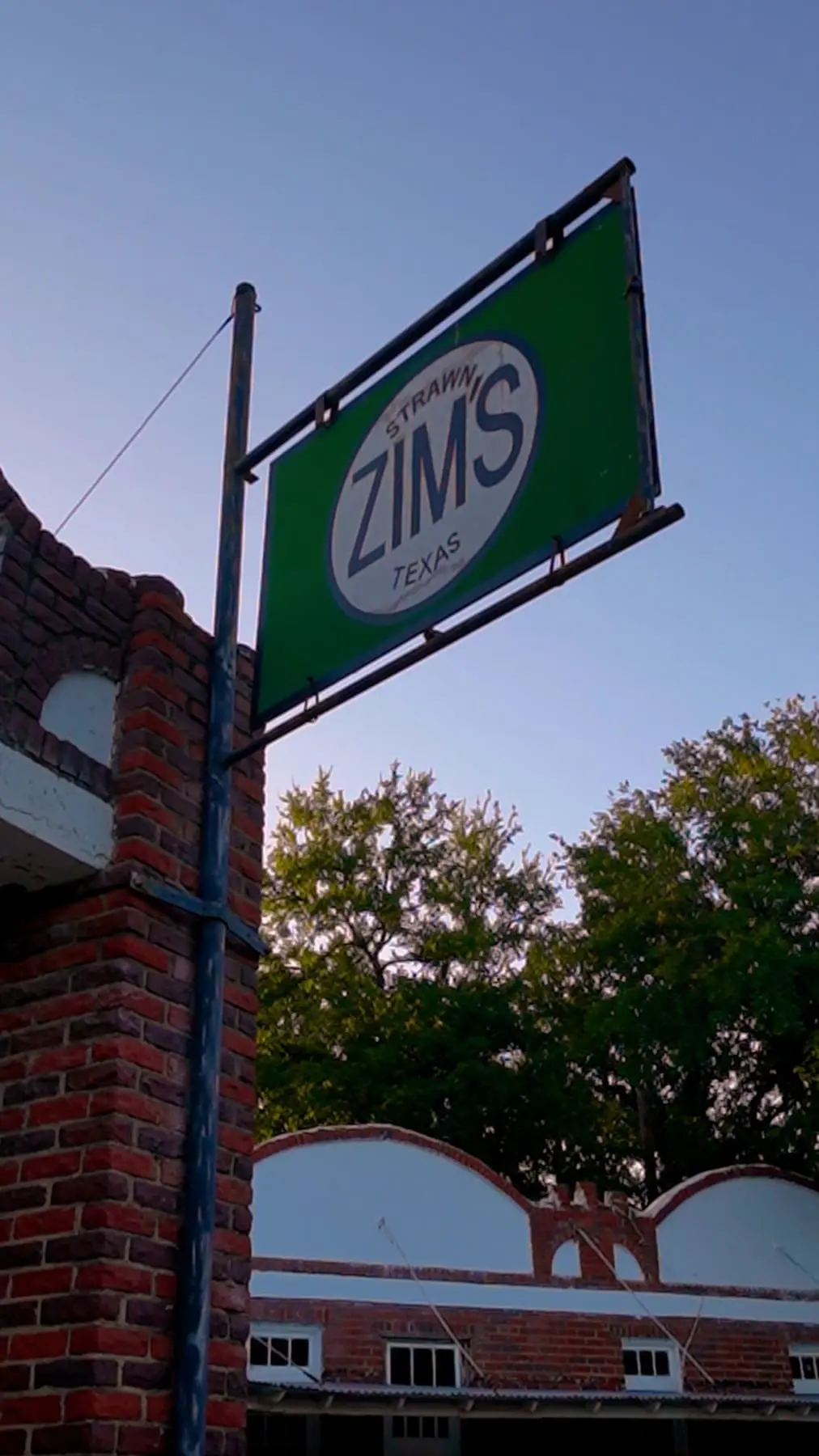 The distinctive Zim’s roadside sign and brick building in Strawn, Texas.