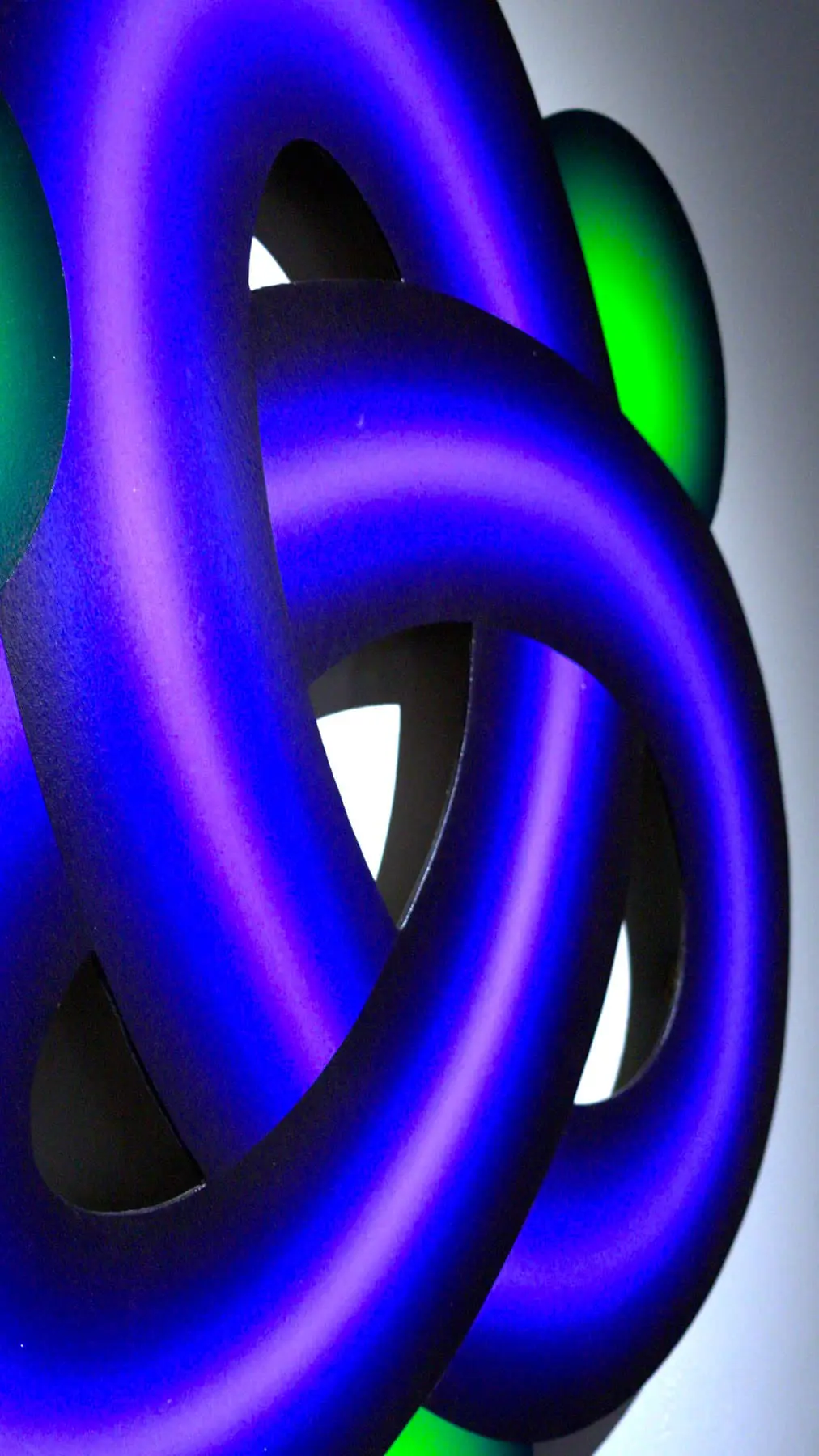 Close detail of a violet, blue and green sculptural ribbon artwork by Benini