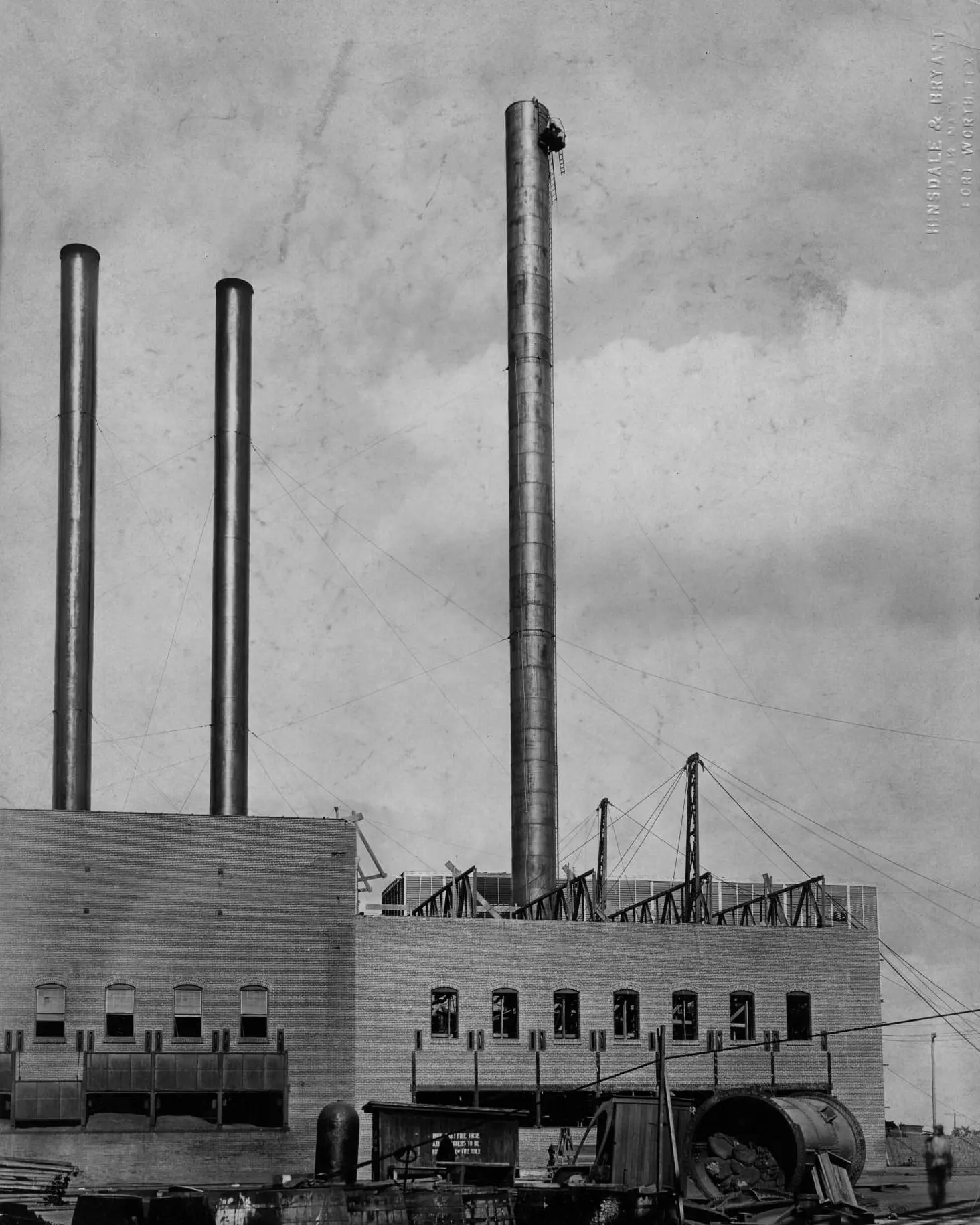 Historic black-and-white photograph of smokestacks and an industrial building at the Swift complex in Fort Worth.