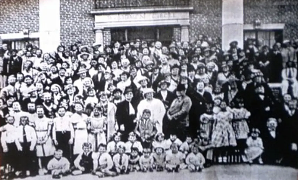 Group portrait of adults and children outside the Woodmen Circle Home