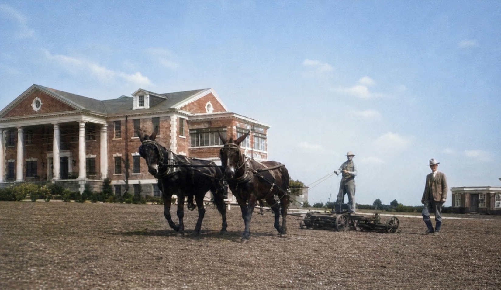 Historic view of workers with a horse drawn implement outside the Woodmen Circle Home in Sherman