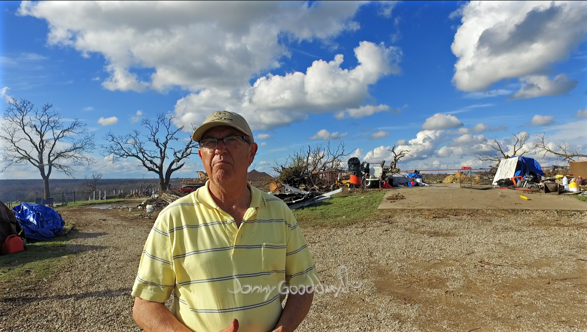 Glen Zell standing beside the damaged home during Jonny Goodday’s 2016 visit near Cool, Texas.