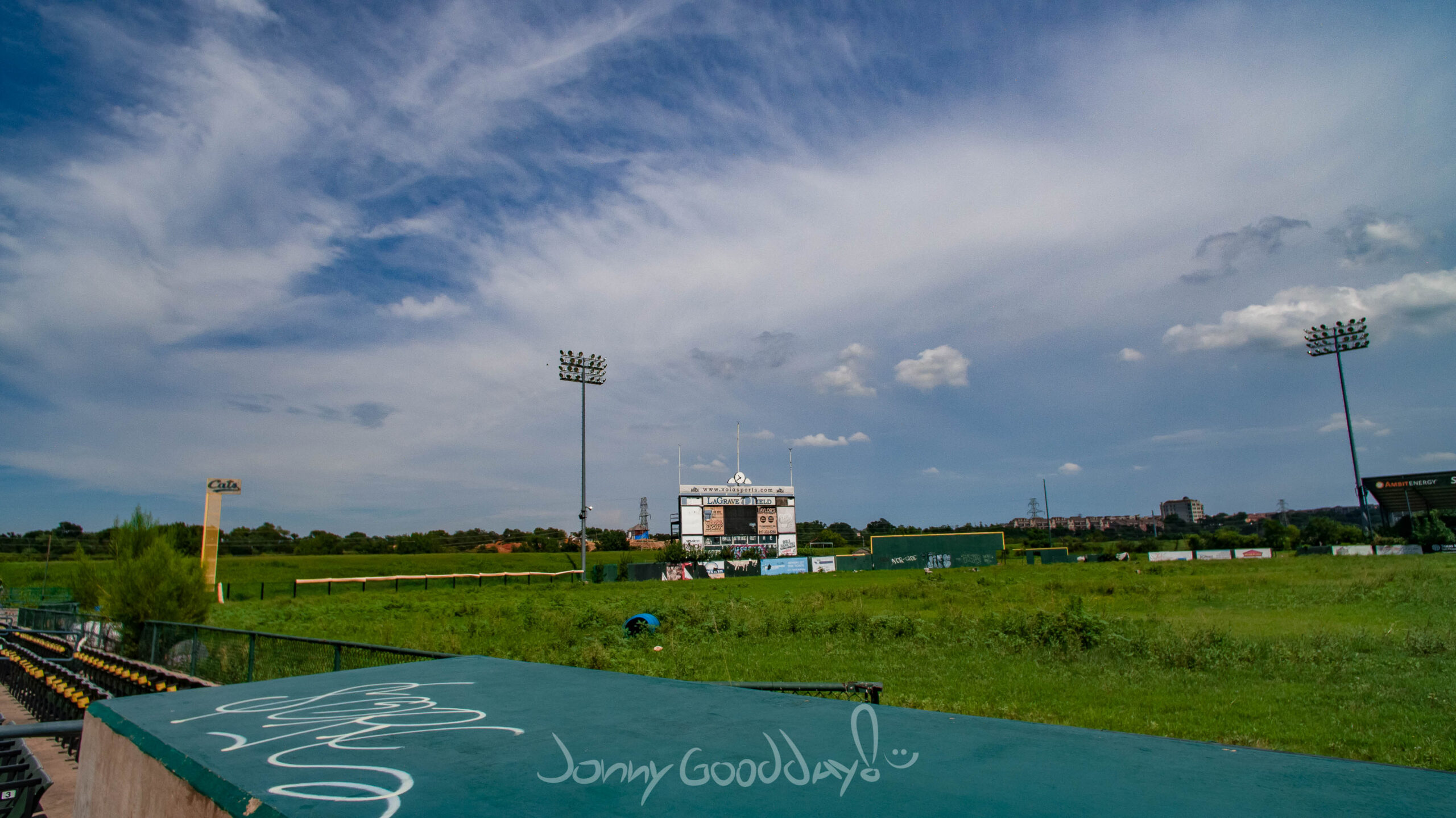 Overgrown LaGrave Field with scoreboard and stadium lights before demolition
